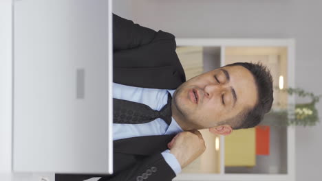Vertical-video-of-Home-office-worker-man-loosening-his-tie-from-stress.